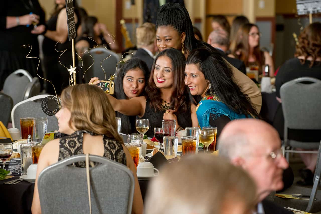 Business students at event taking selfie