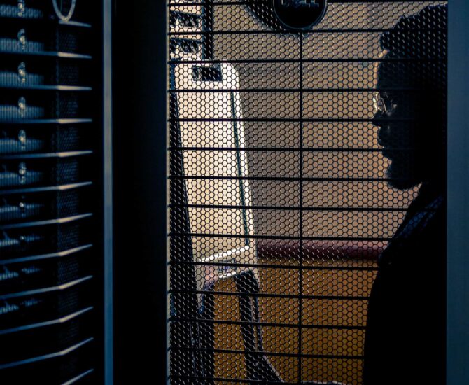 A male looking at a computer processing unit.