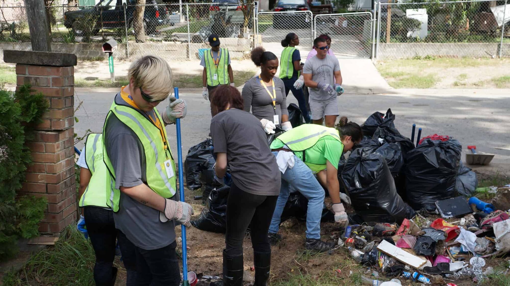 A group of students picking up garage from the ground.