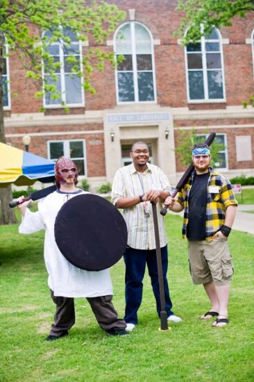 three students with different costumes