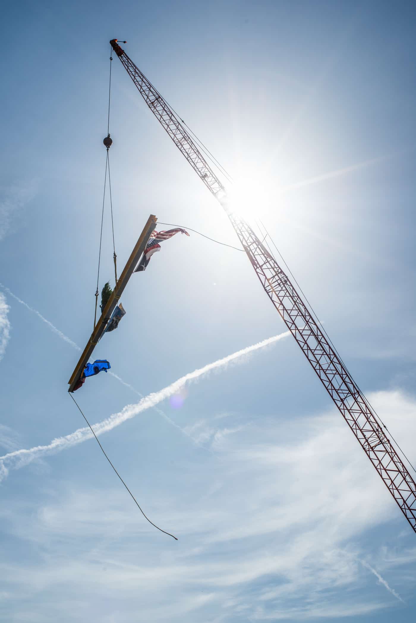 A crane holding a pole.