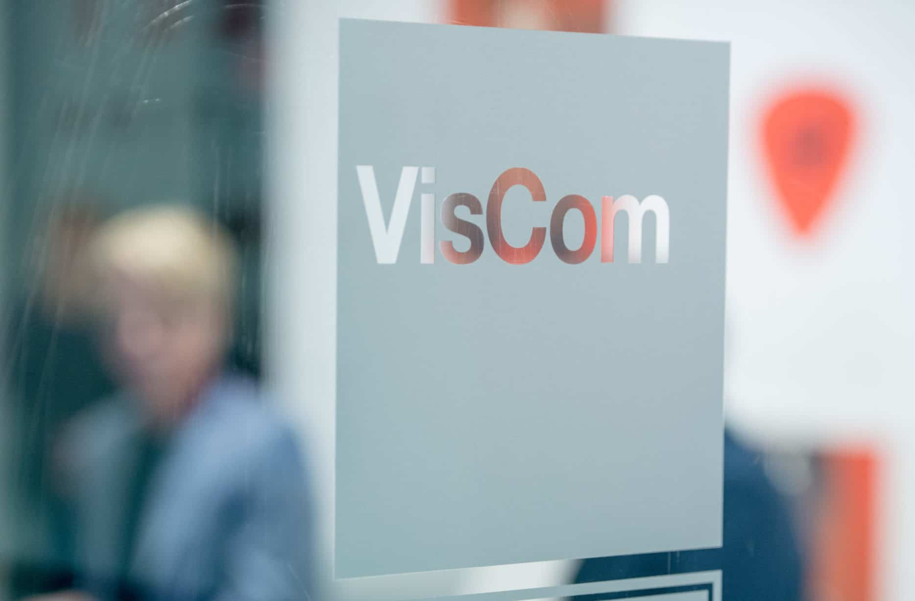 VisCom logo on glass door.