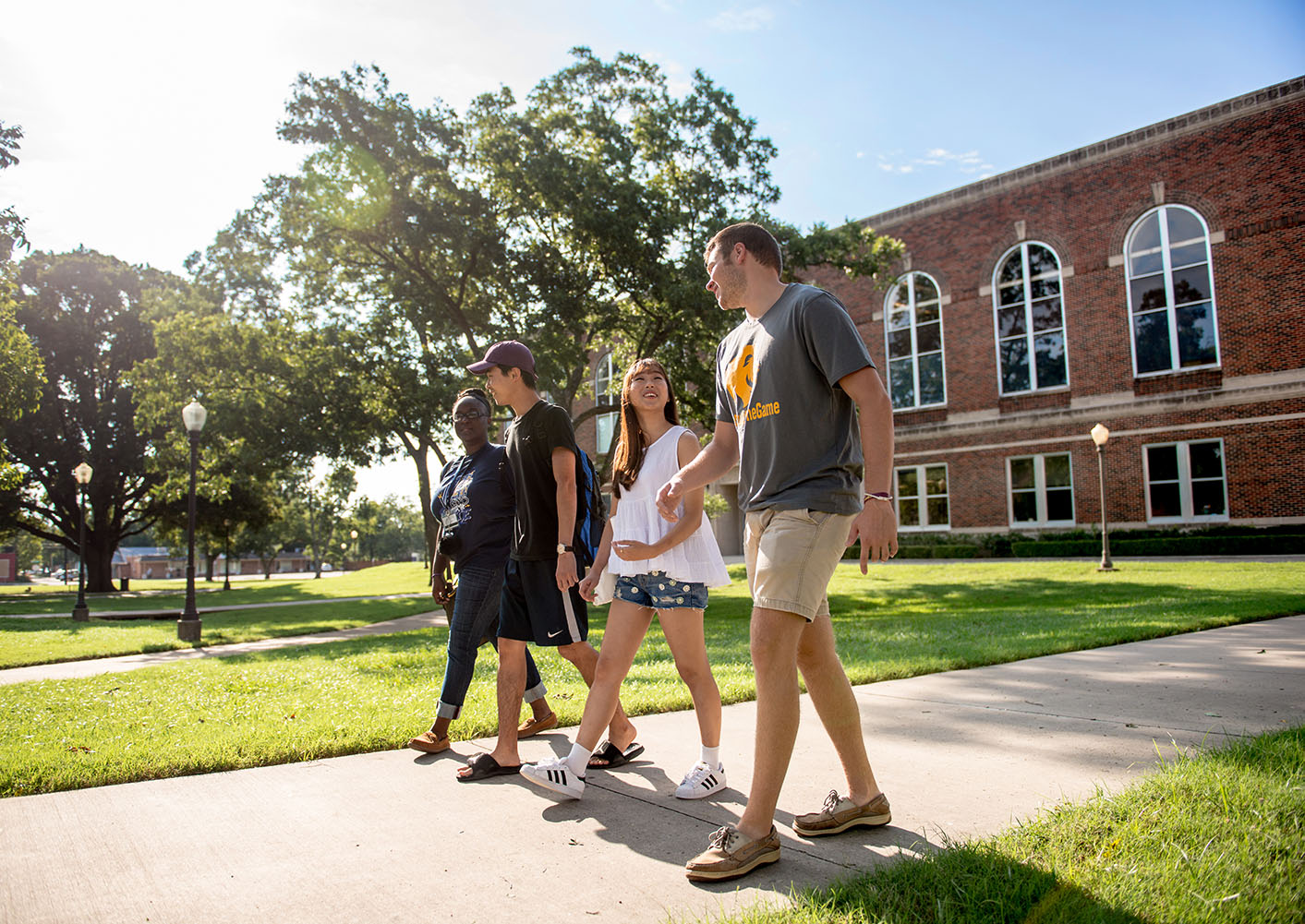 Four students walking on the East Texas A&M campus.