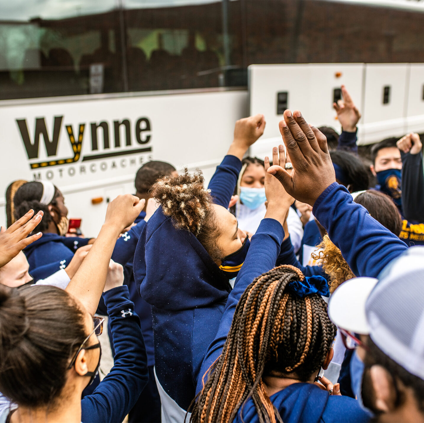 ETAMU track team by a bus.
