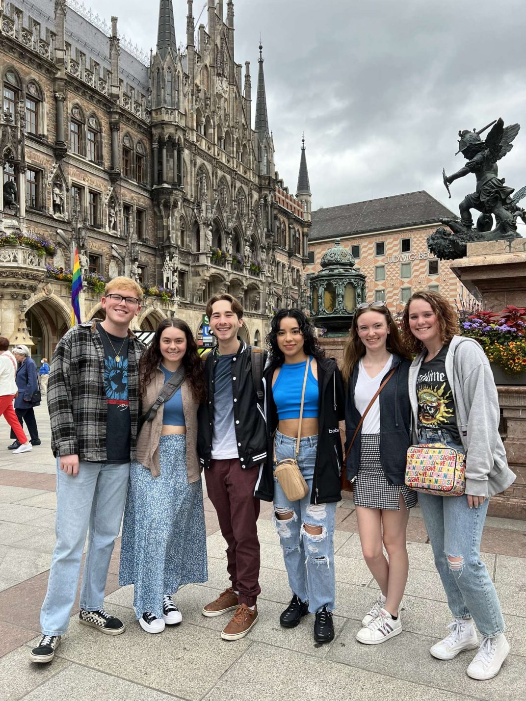 A group of students posing in front of a castle.