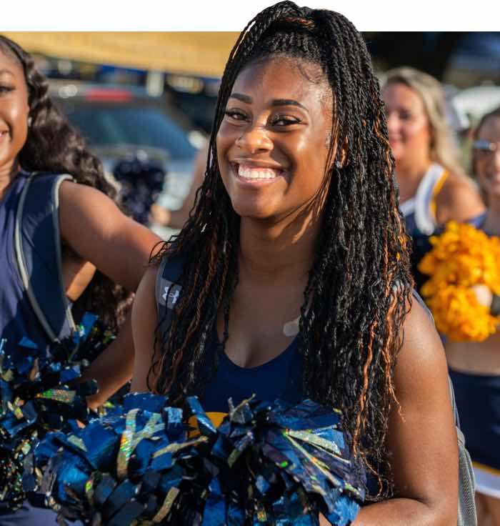 ETAMU Cheerleader smiling at the camera.