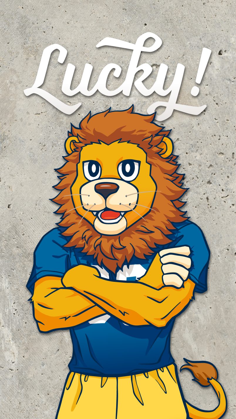 Lucky! lion mascot wearing a sports uniform with arms crossed