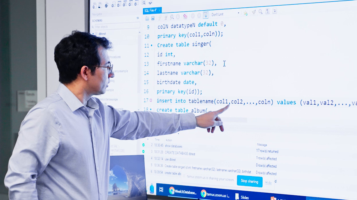 man looking at projection of code