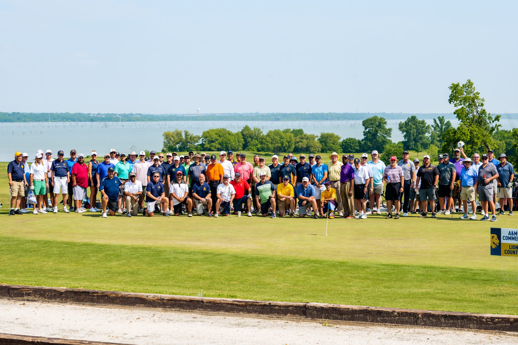 A group of individuals watching a golf tournament.
