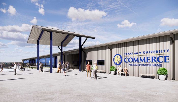 East Texas A&M University arena building with a large blue and yellow logo on the front, showing a modern exterior with people standing outside the entrance.
