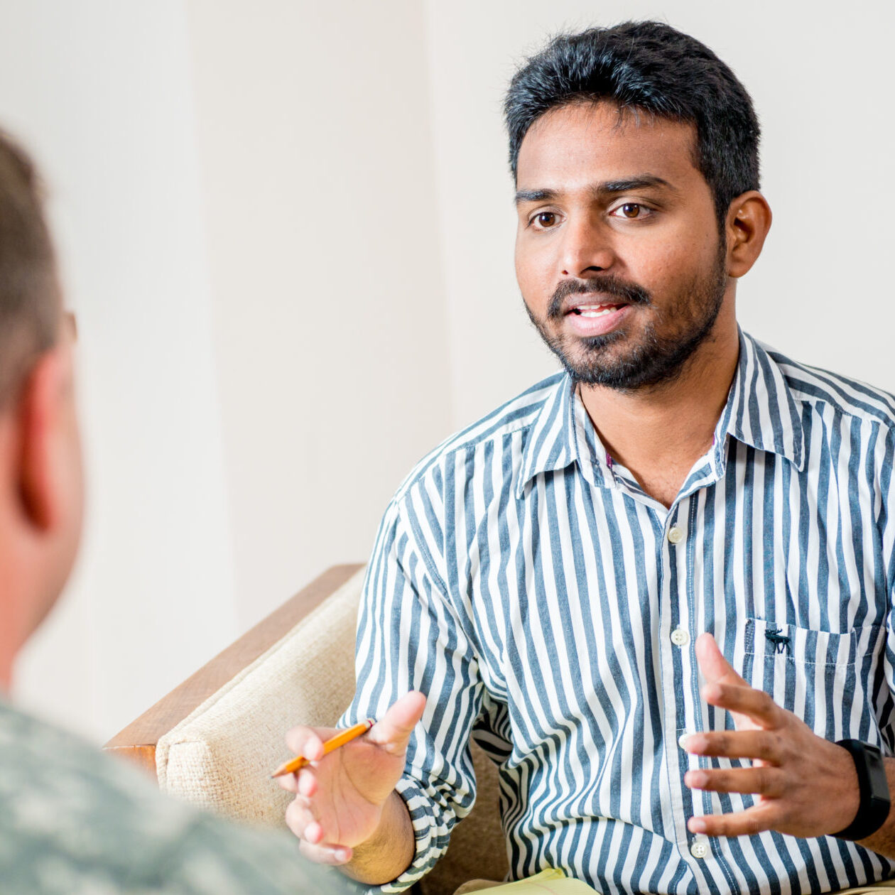 Social worker talking to man in the military.
