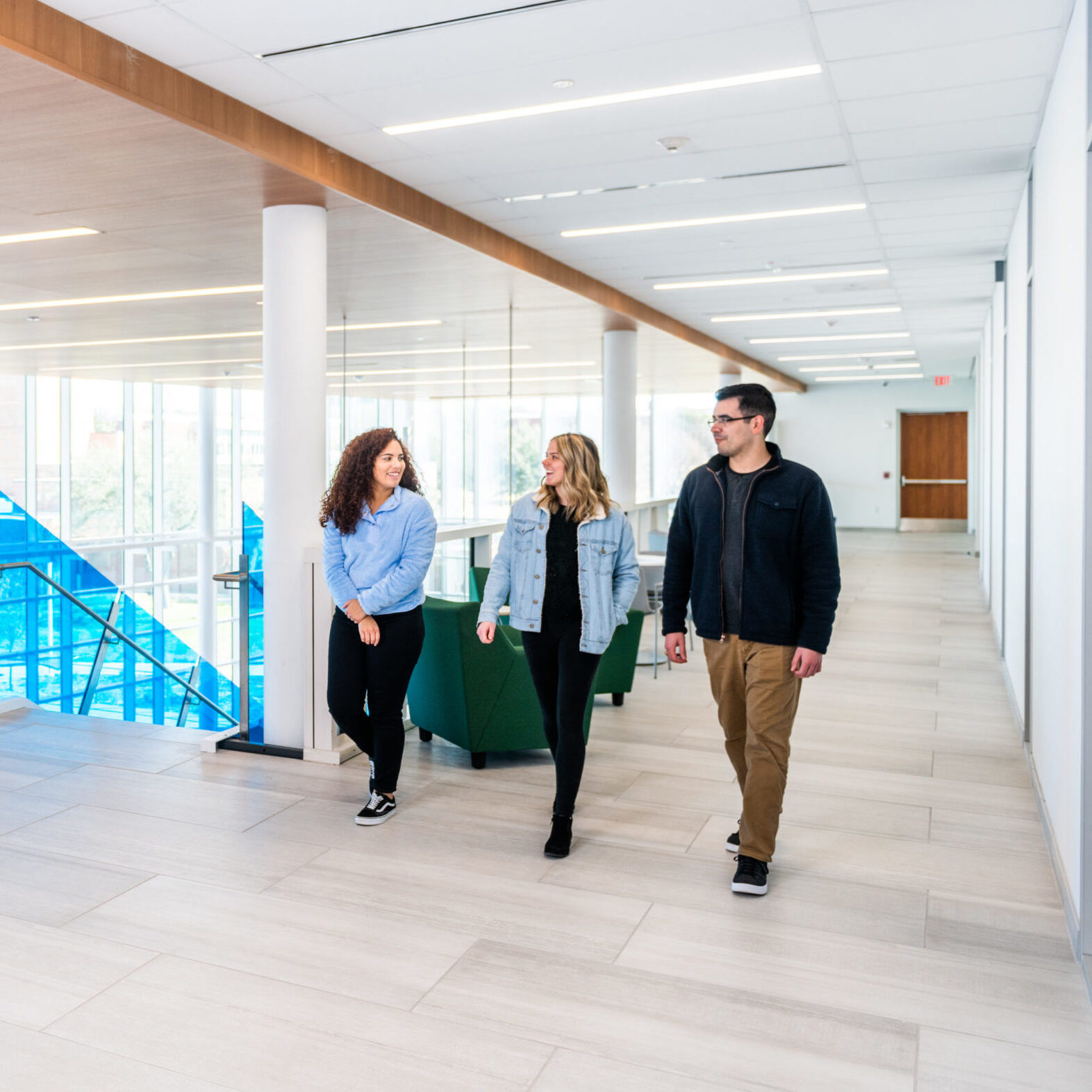 Three student walking inside the East Texas A&M Nursing Health Sciences building.