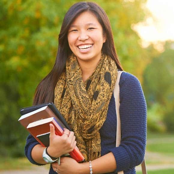 Girl with books having a beautiful smile on her face