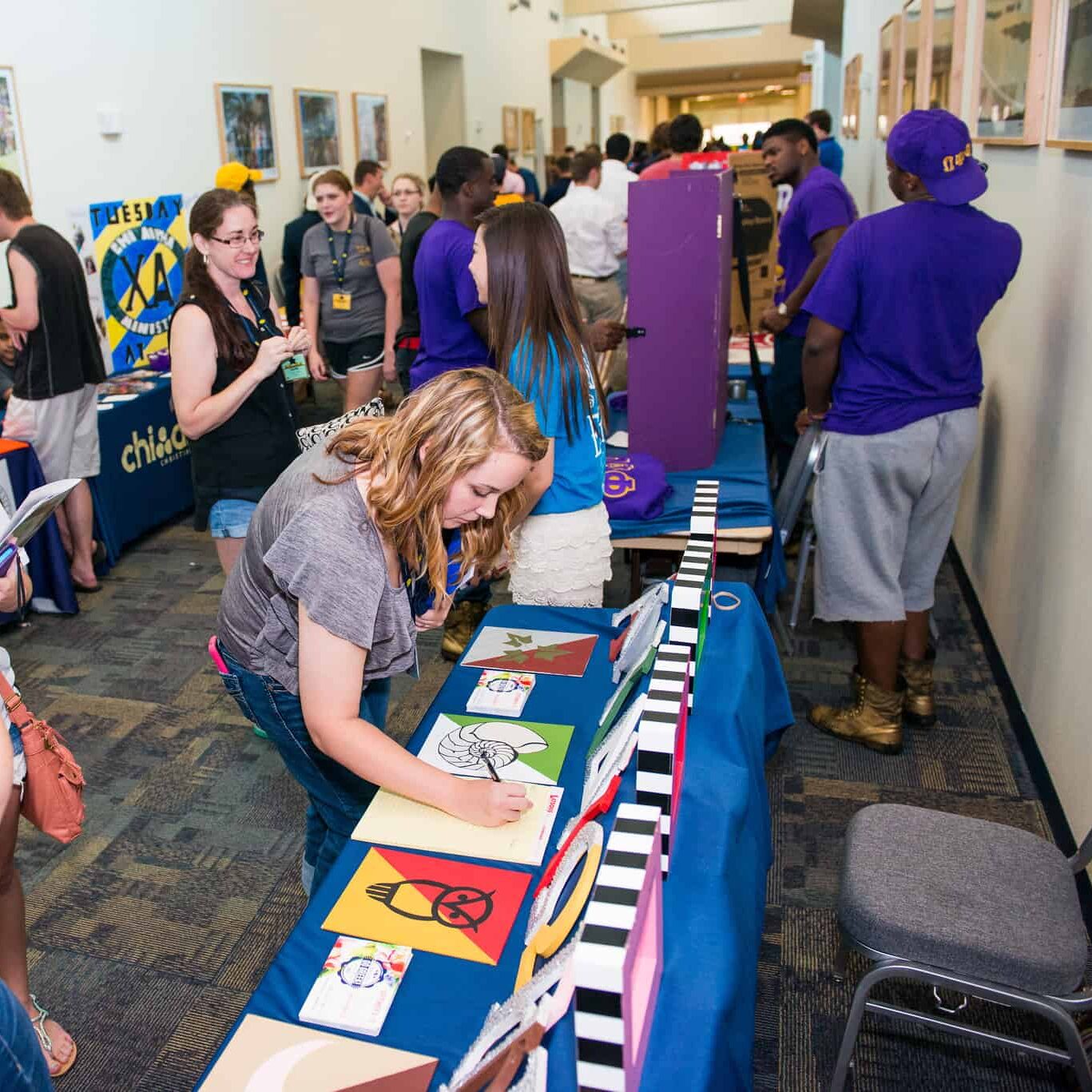 Young lady signing up for an organizations.