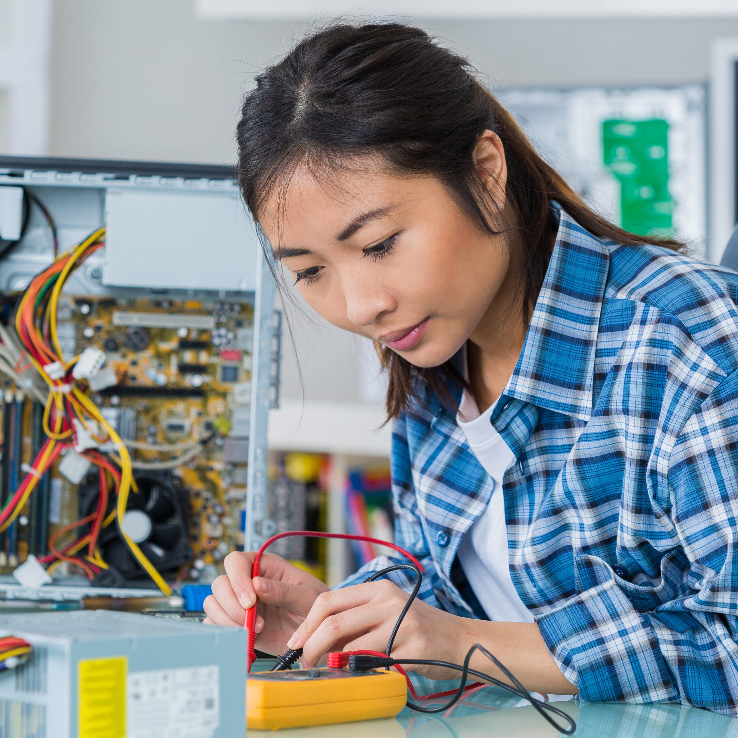 student girl in technology fixing computer hard drive