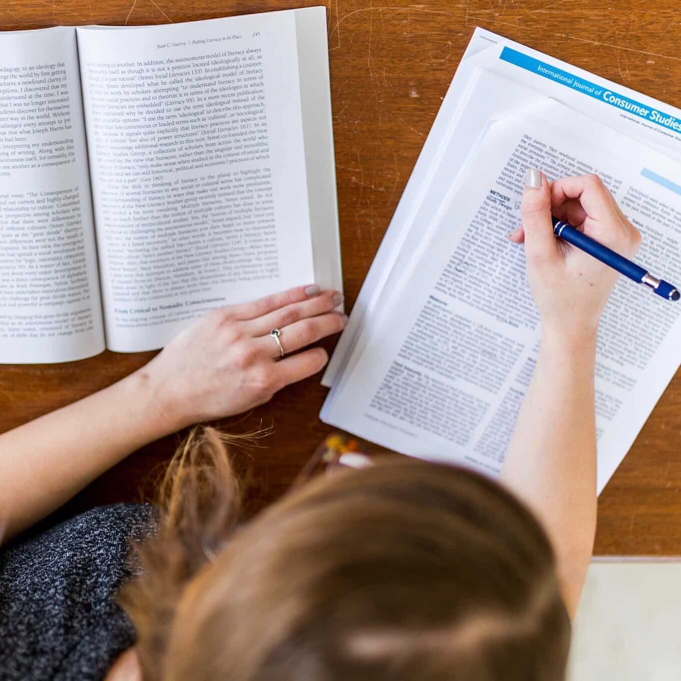 A student studying sitting down at a desk.