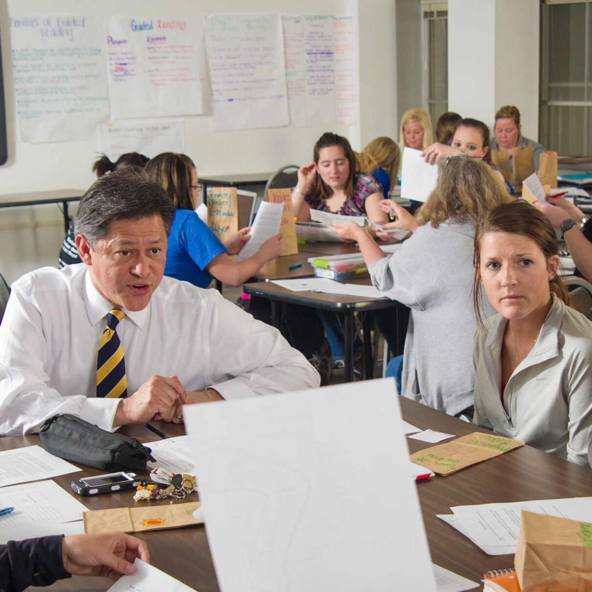 Faculty speaking with students in active learning classroom