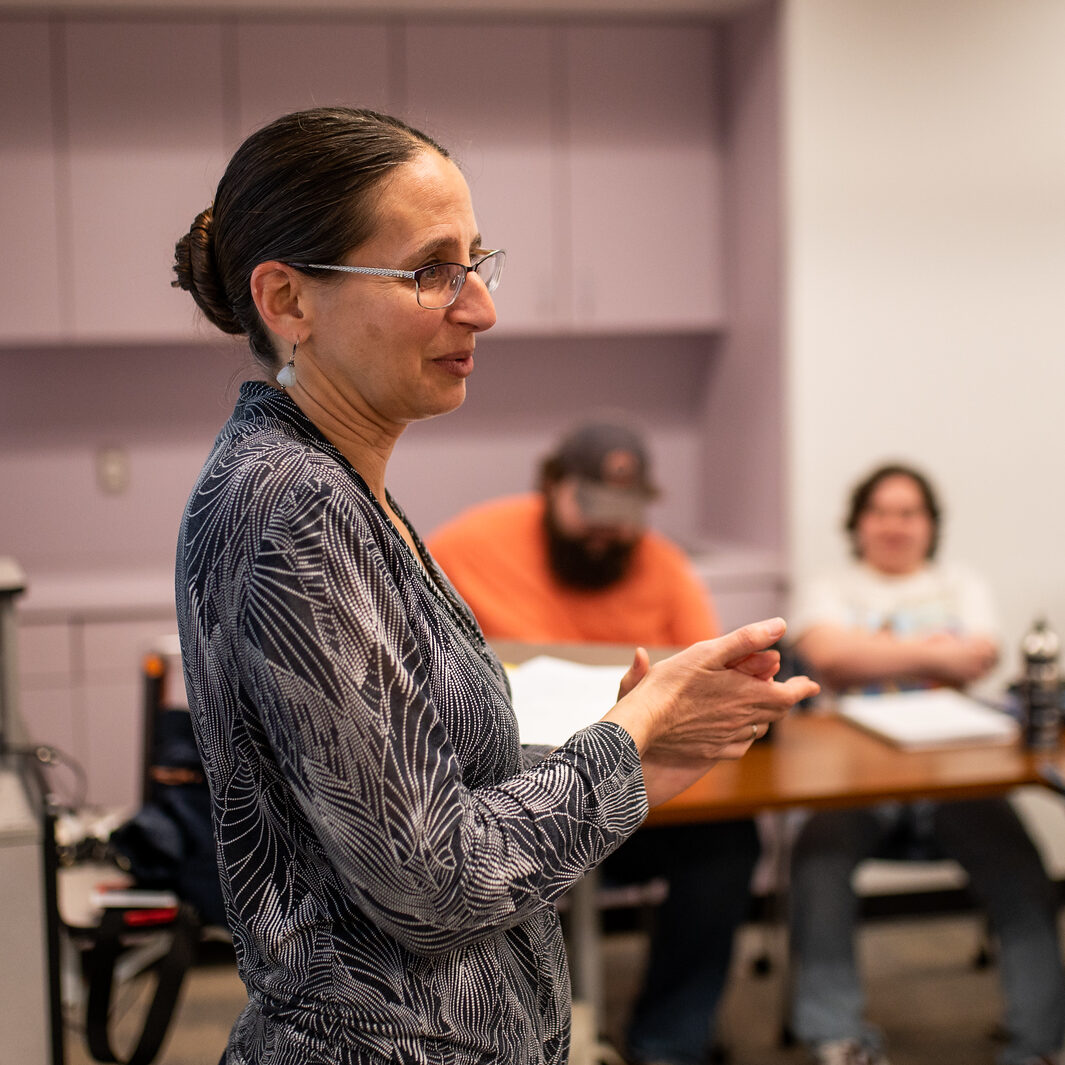 A female professor lecturing during class.