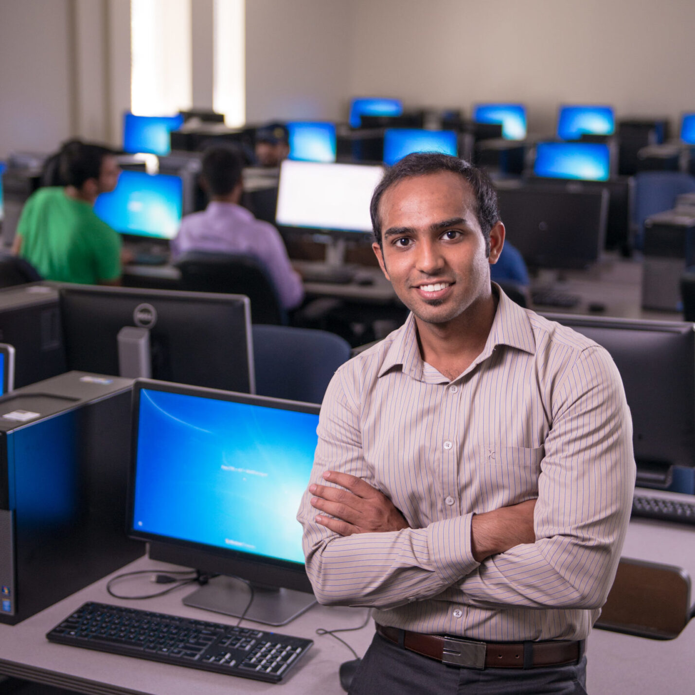 Man standing in front of a computer in a lab