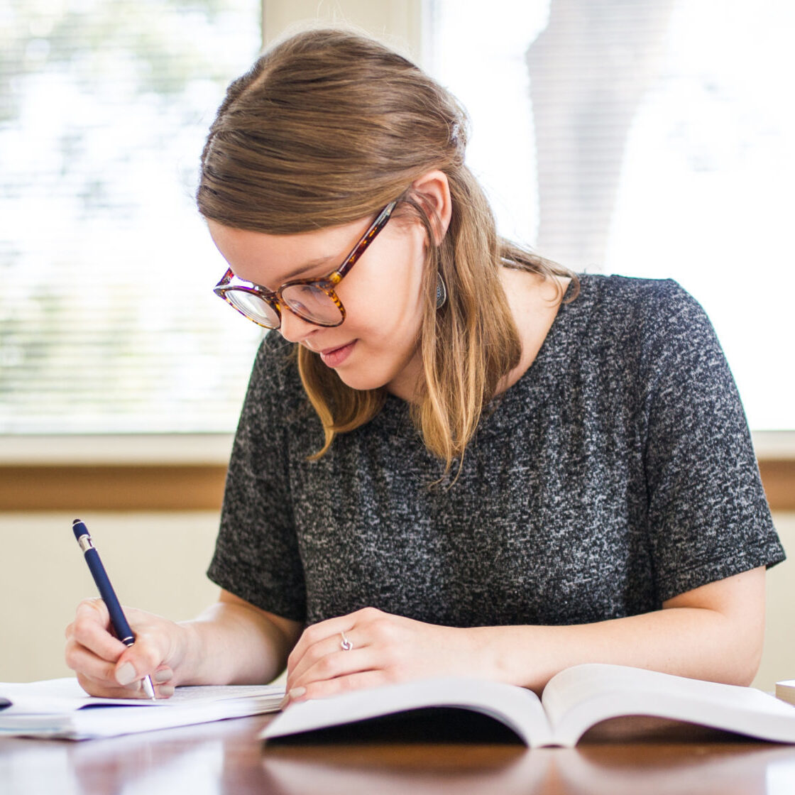 Woman studying at a table.