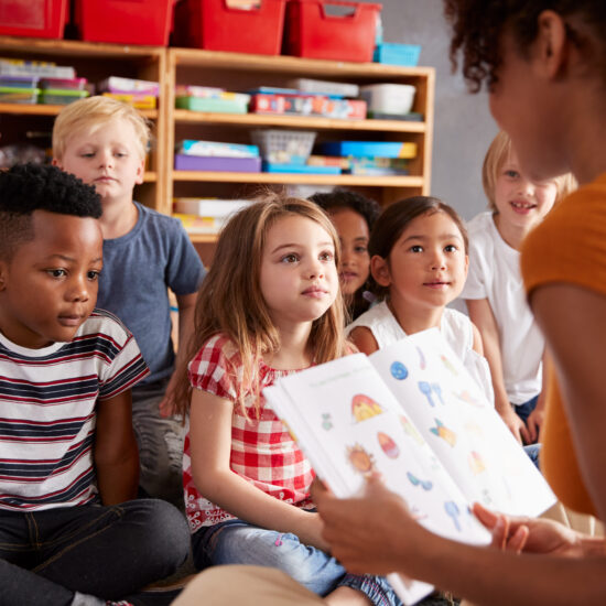 A teacher reading out loud to students.