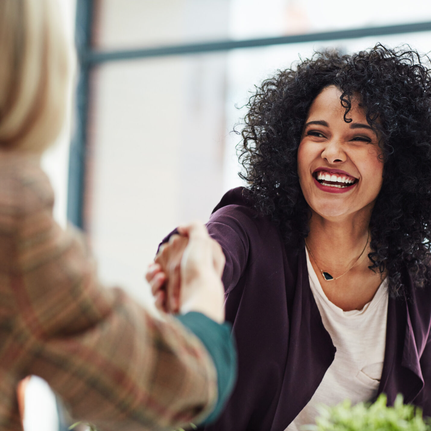 Handshake with a happy, confident and excited business woman
