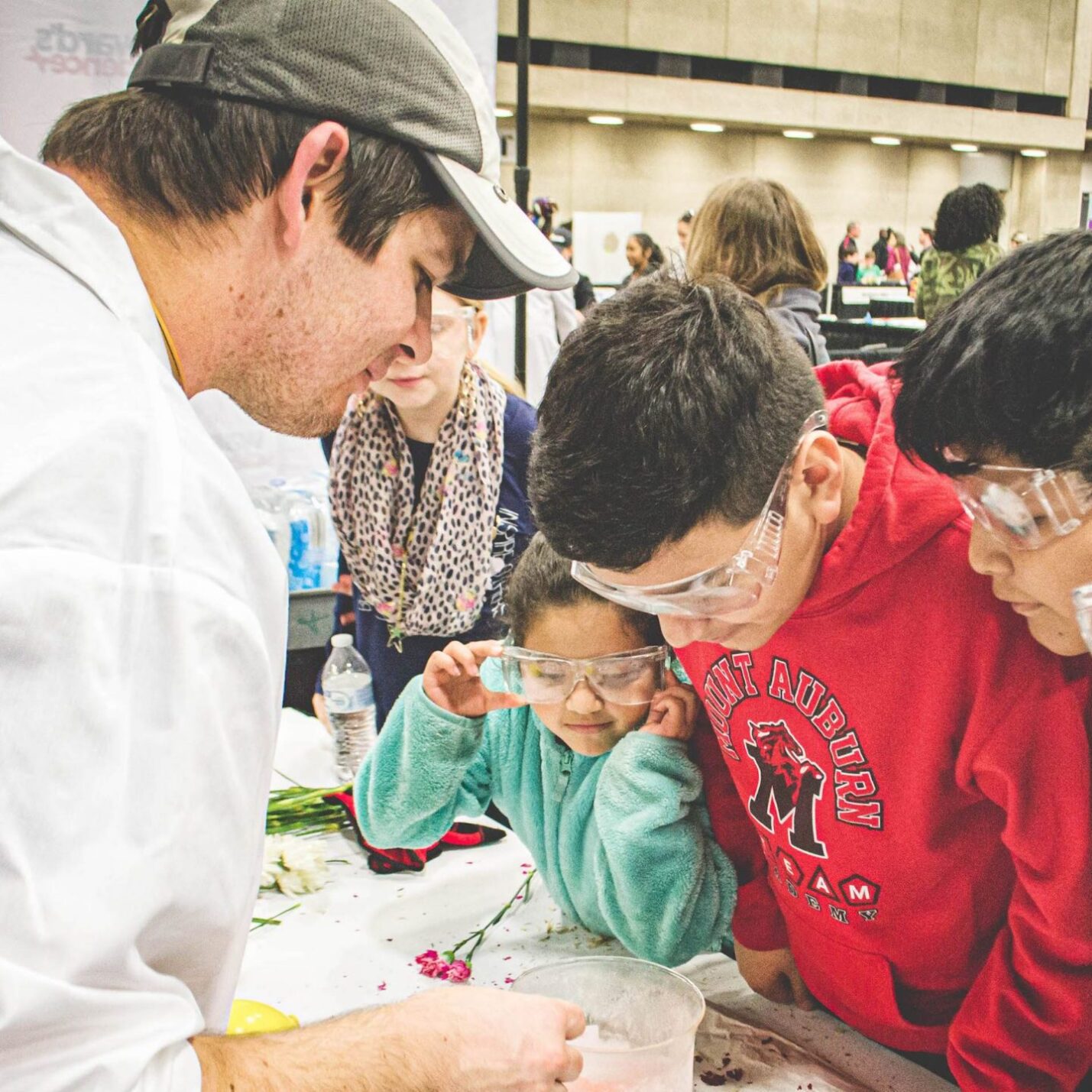 Students engaged in a science experiment that is being instructed by the instructor.