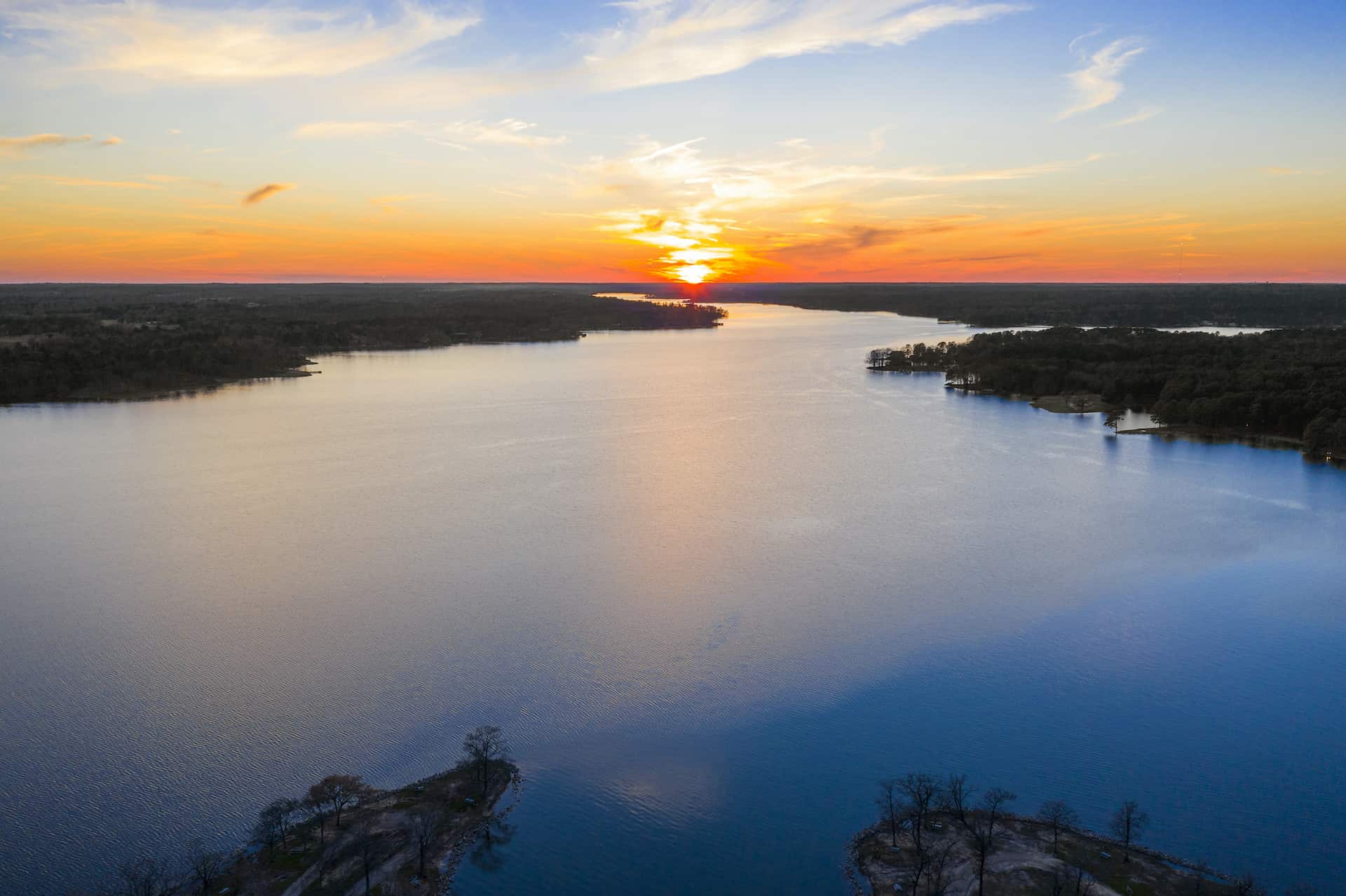 A lake with the sunset behind it.