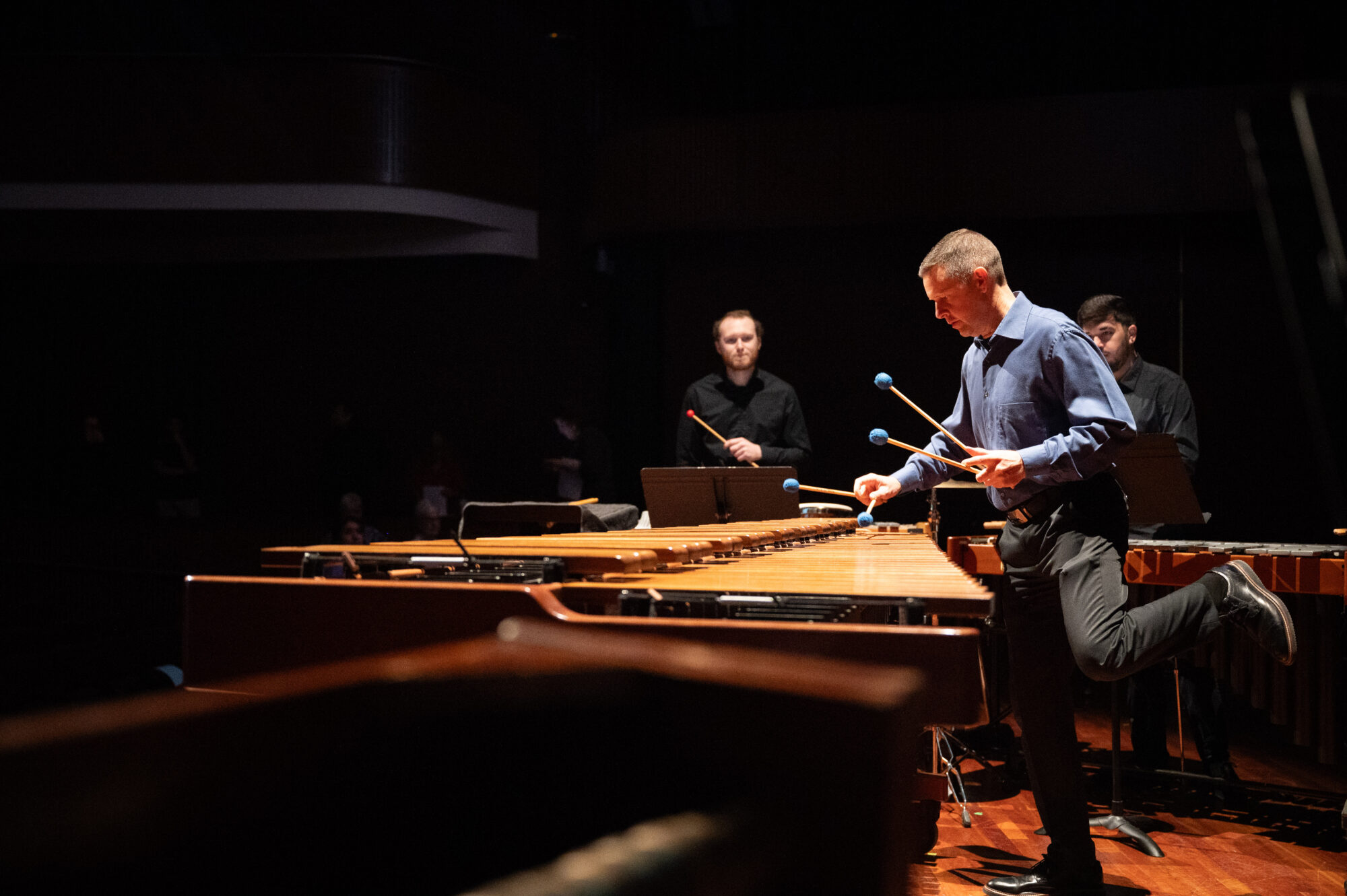 A percussion ensemble performing on stage.