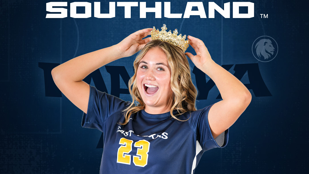 A soccer player posing with a crown