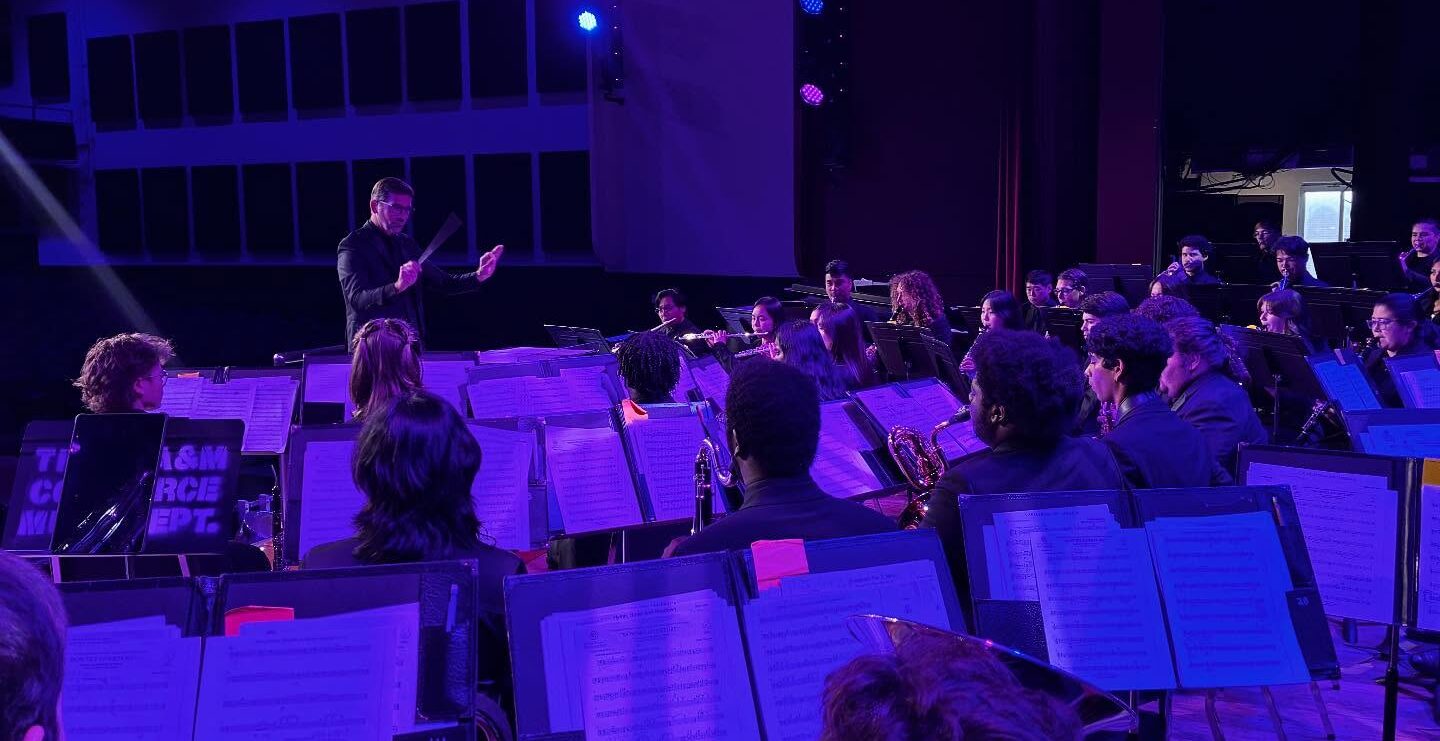 A conductor leading an ensemble during a concert.