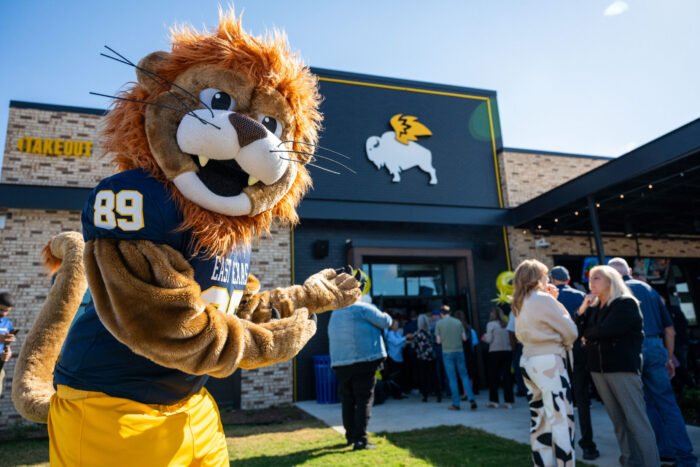A lion mascot welcoming patrons to a restaurant.