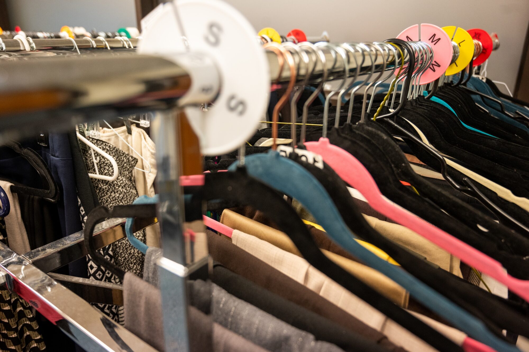 Racks of clothing on hangars.