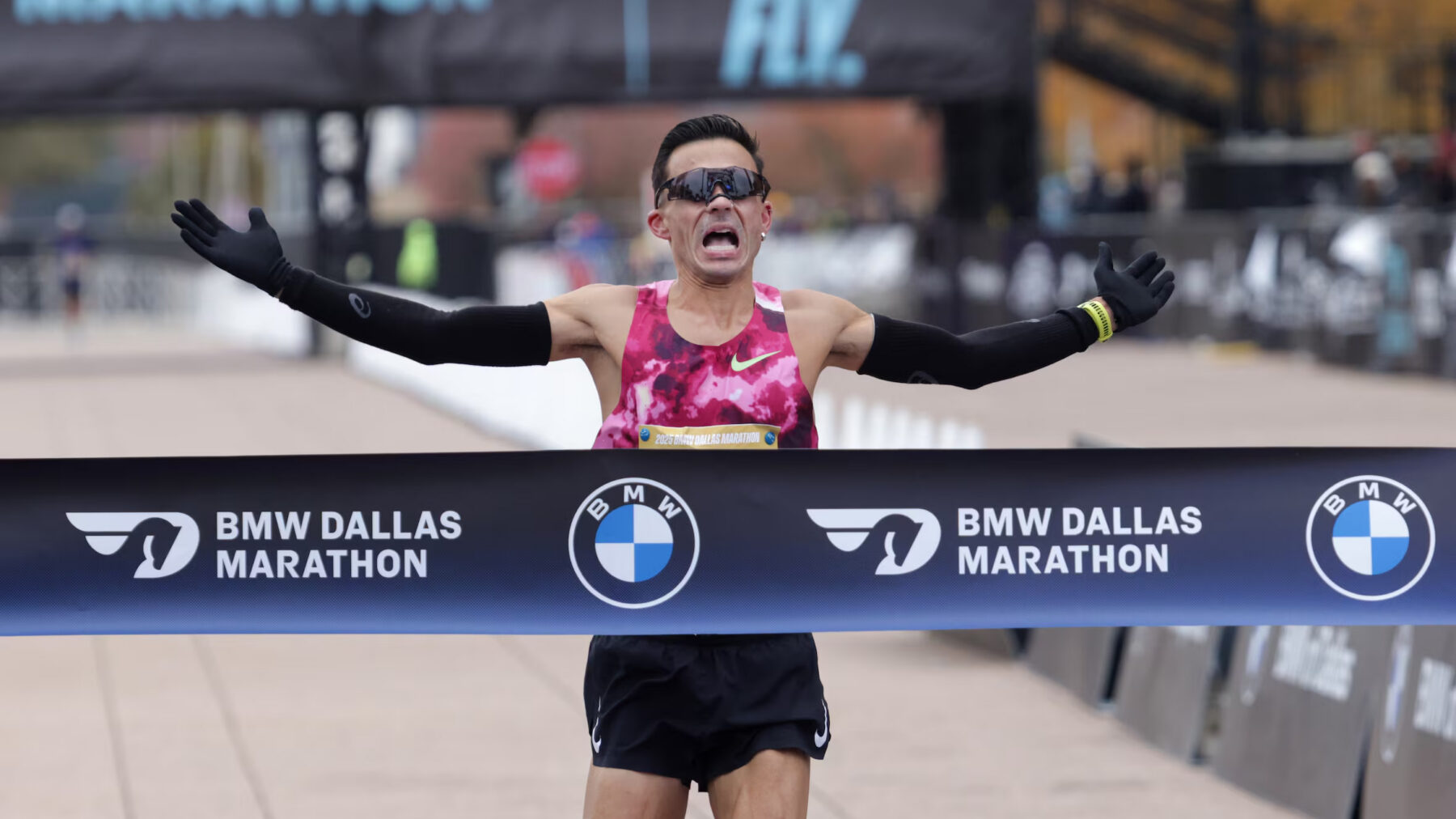 A runner crossing the finish line in a half-marathon.