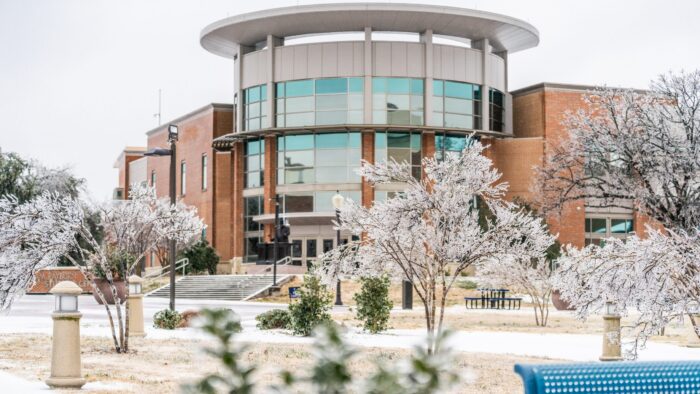 A building on a college campus in a snowy, winter setting.