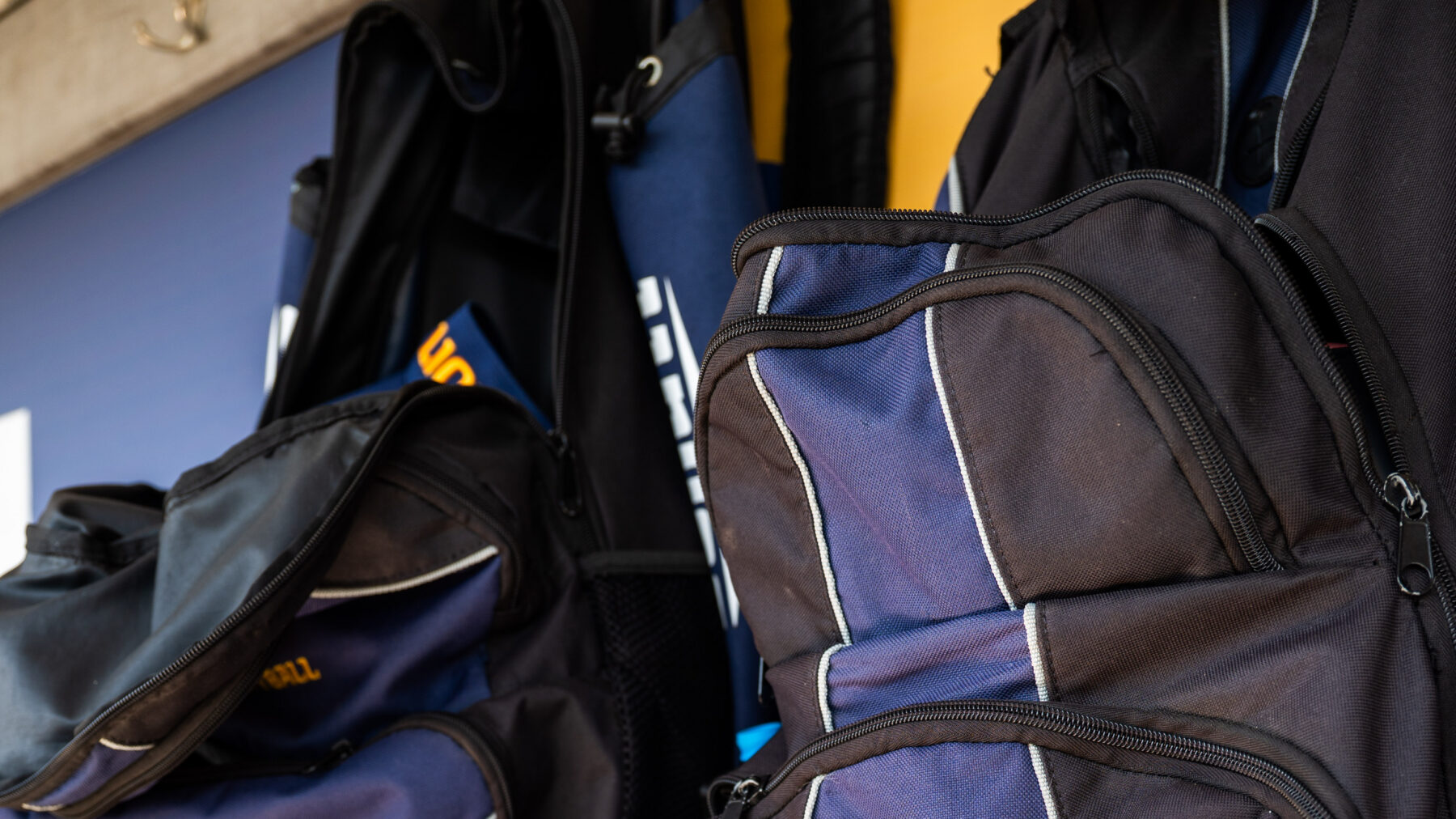 A photo of various softball equipment including gloves, a ball and a catcher's mask.
