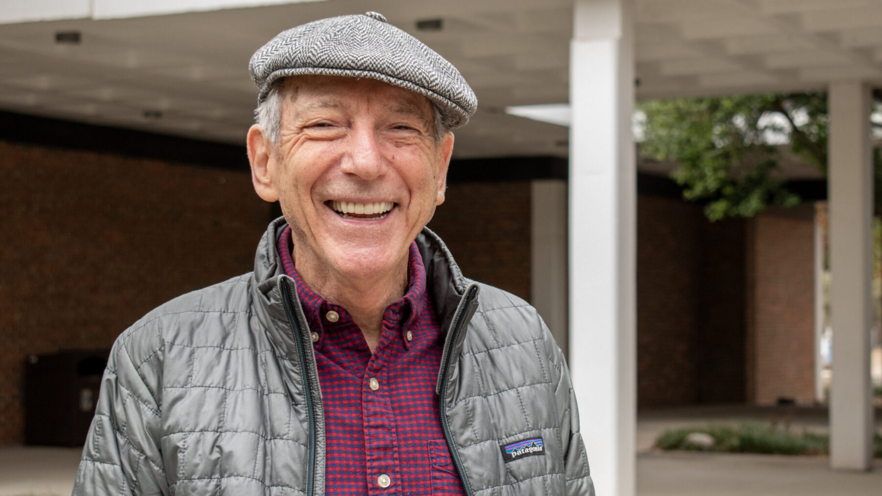 A headshot photo of a person outdoors.
