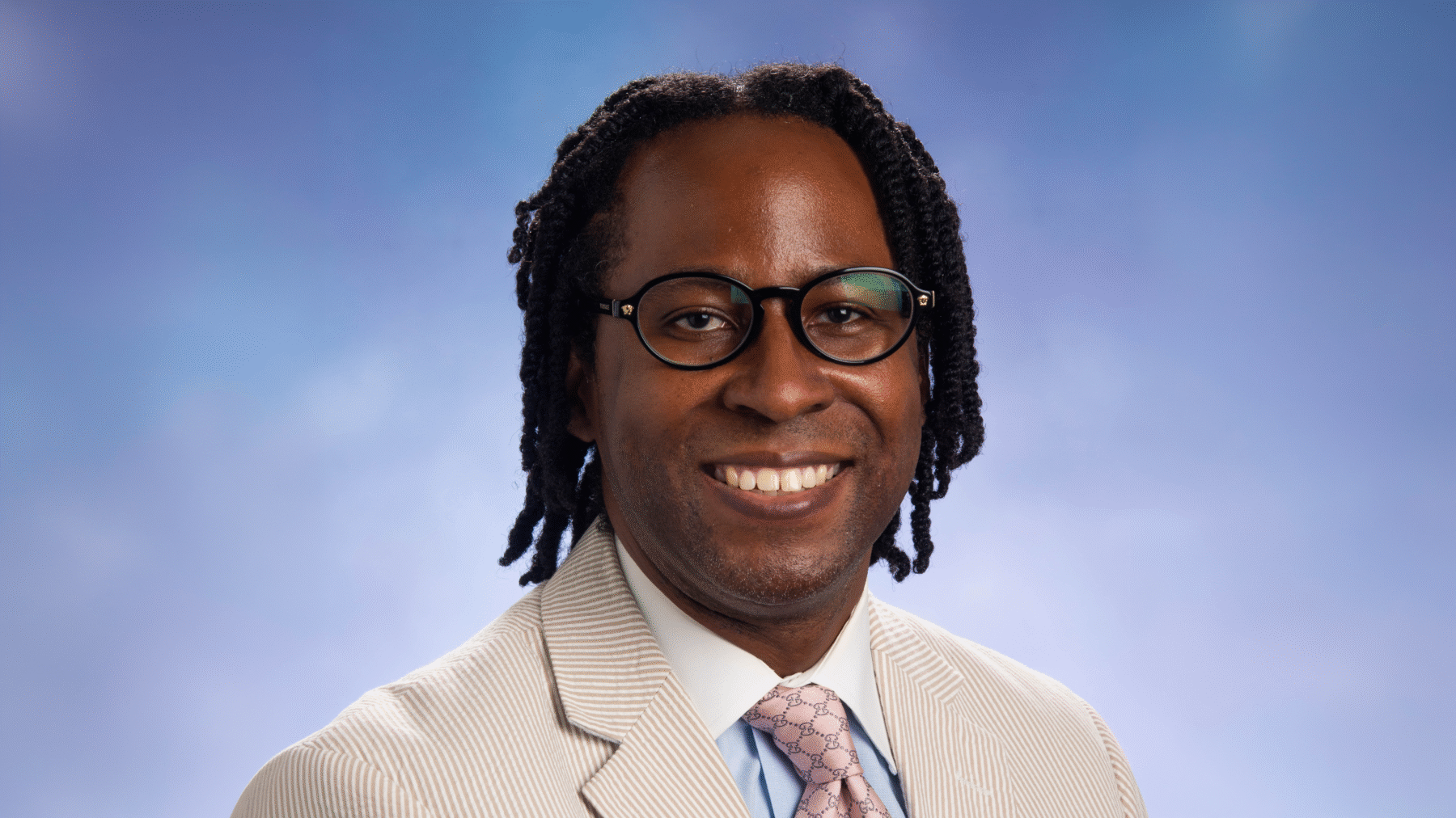 Arthur Lumzy smiling in a headshot