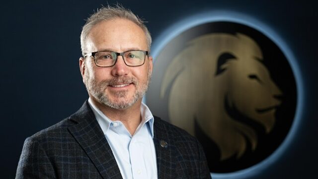 A headshot photo of Chris Shaw in front of the East Texas A&M logo