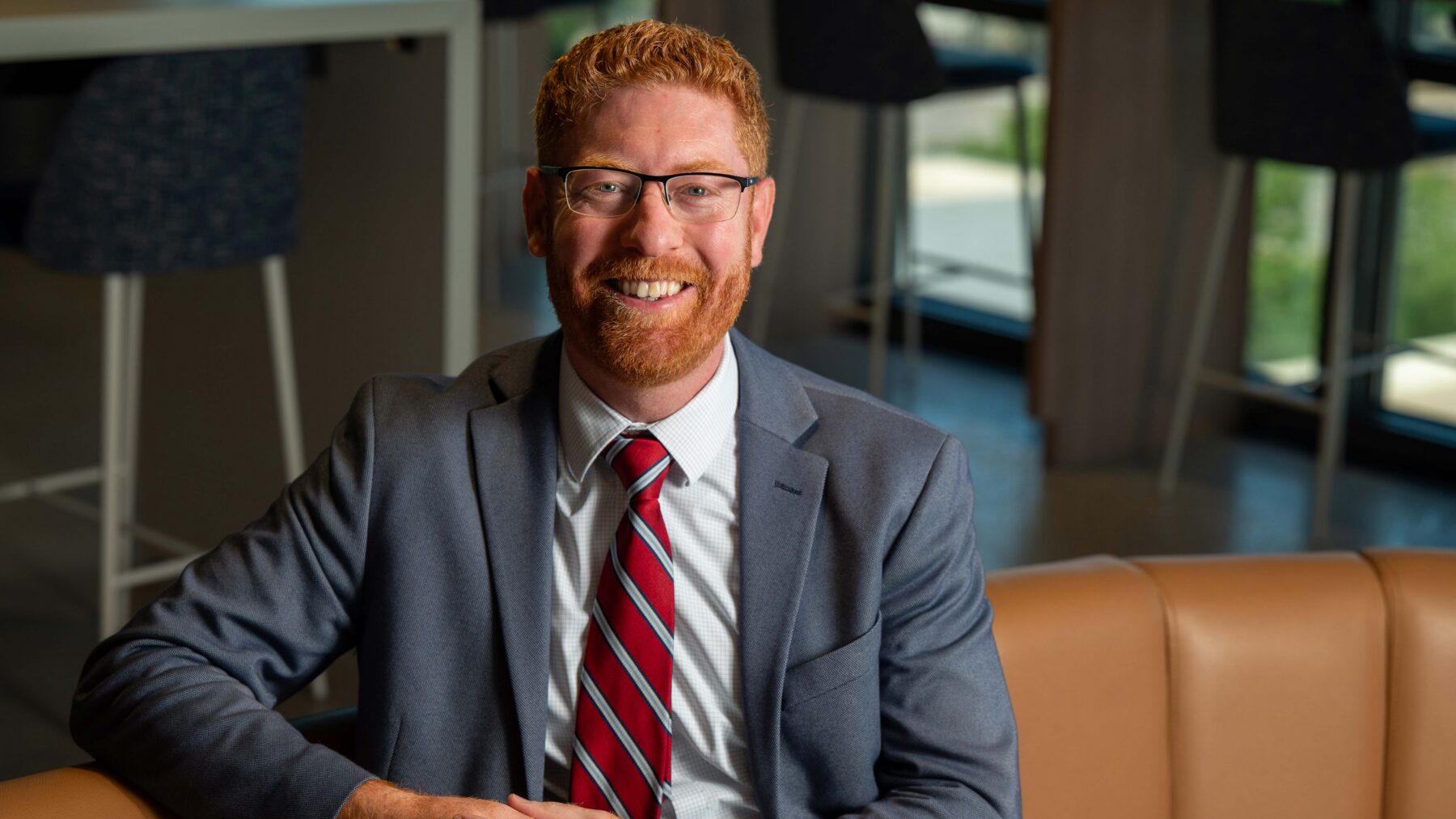 Man sitting on a couch smiling.