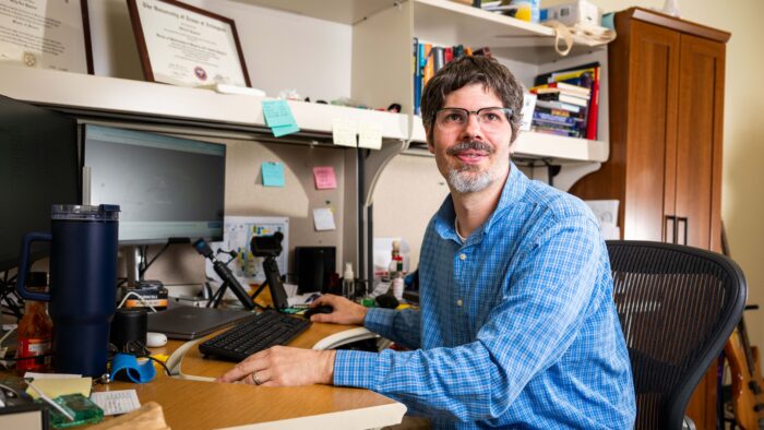 A man sitting at a computer desk.