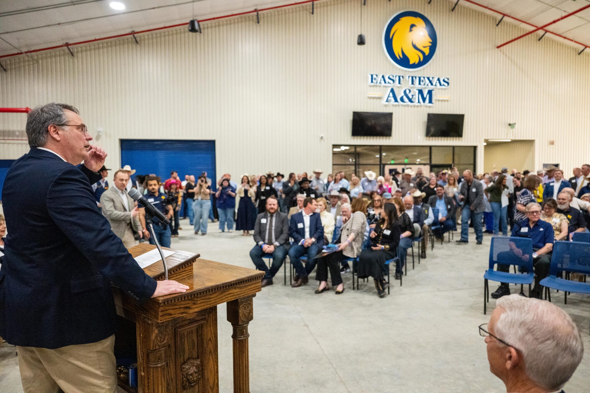 Dr. Mark Rudin speaks to a crowd of people at the Spur grand opening.