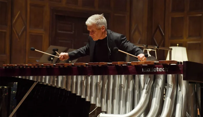 A man plays a percussion instrument.
