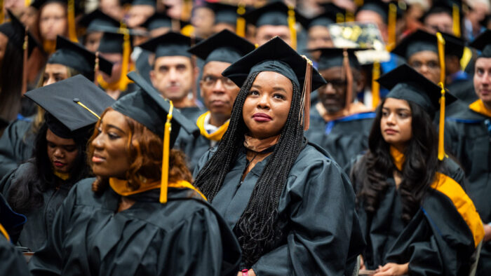 Rows of college graduates during a graduation ceremony.