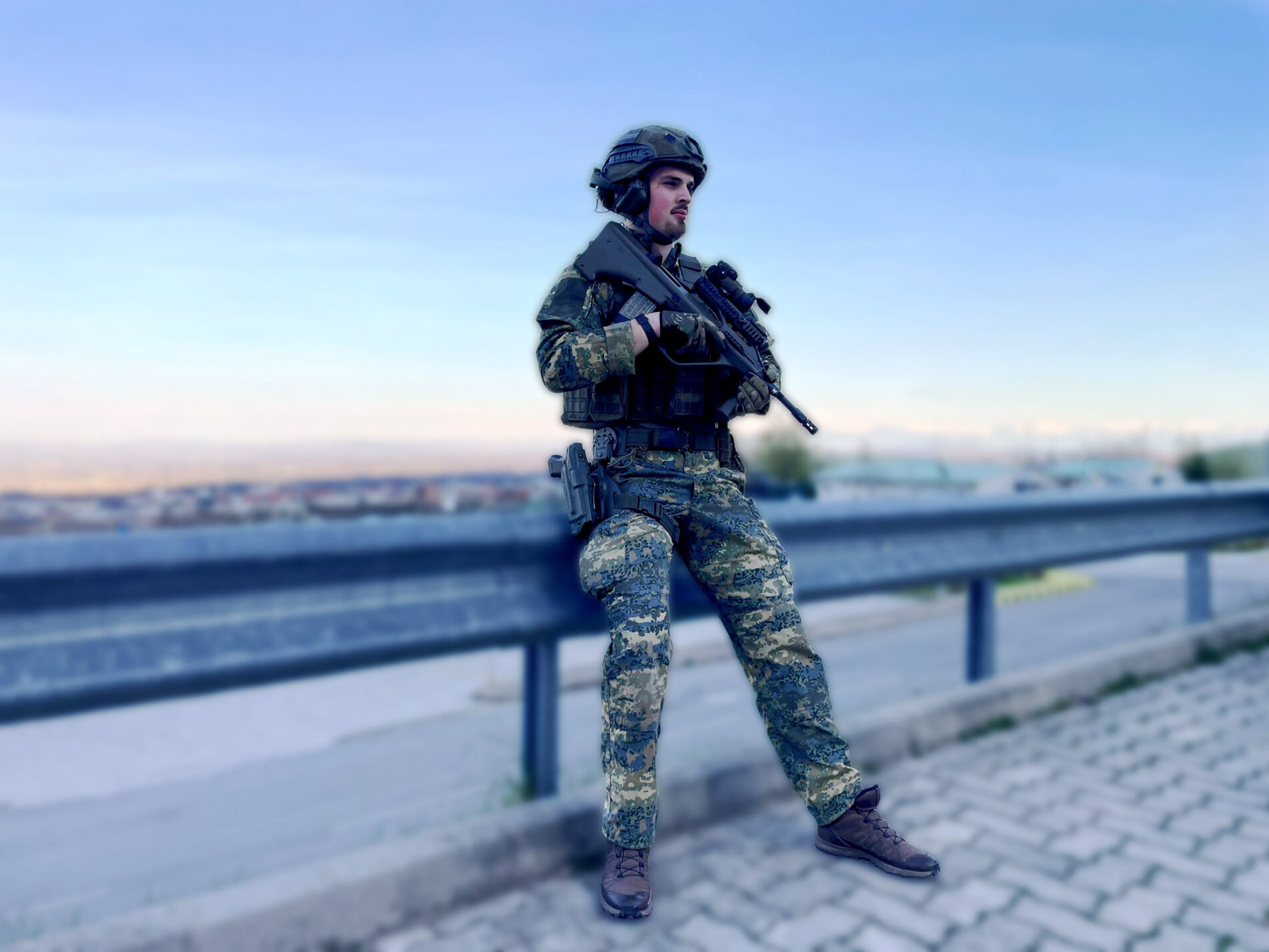 A person in full military tactical gear holding an assault rifle.