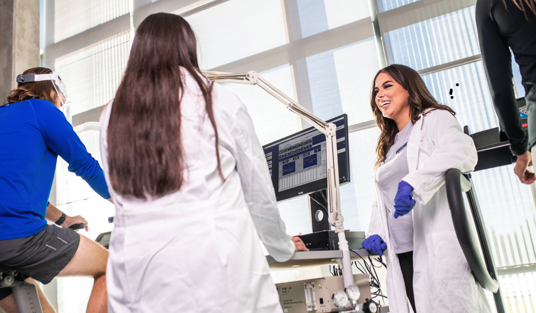 two students smiling while conducting an exercise research.