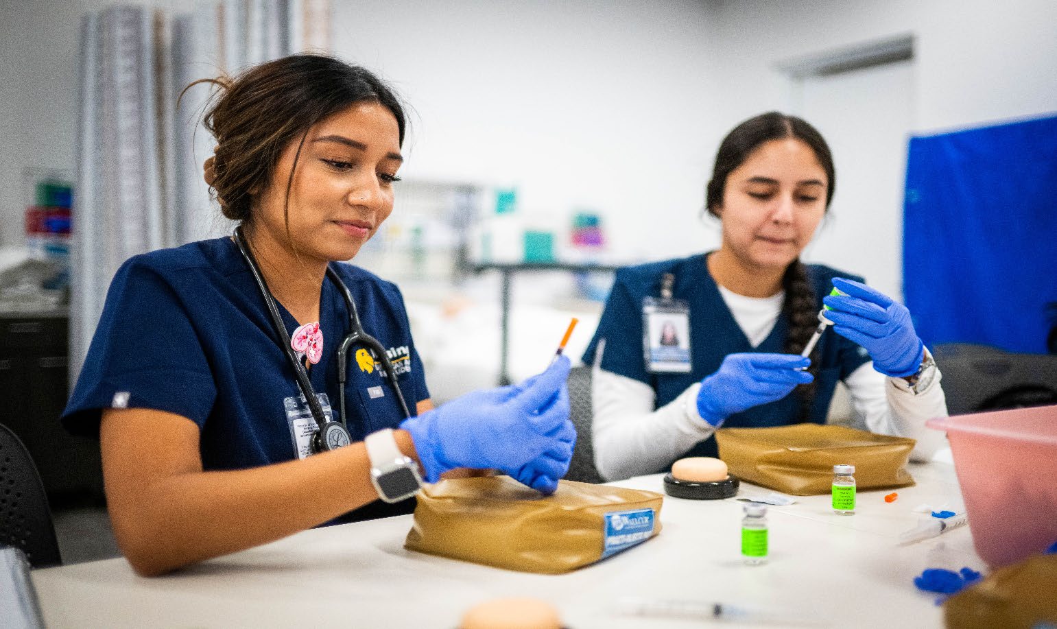 nursing students examine syrnges