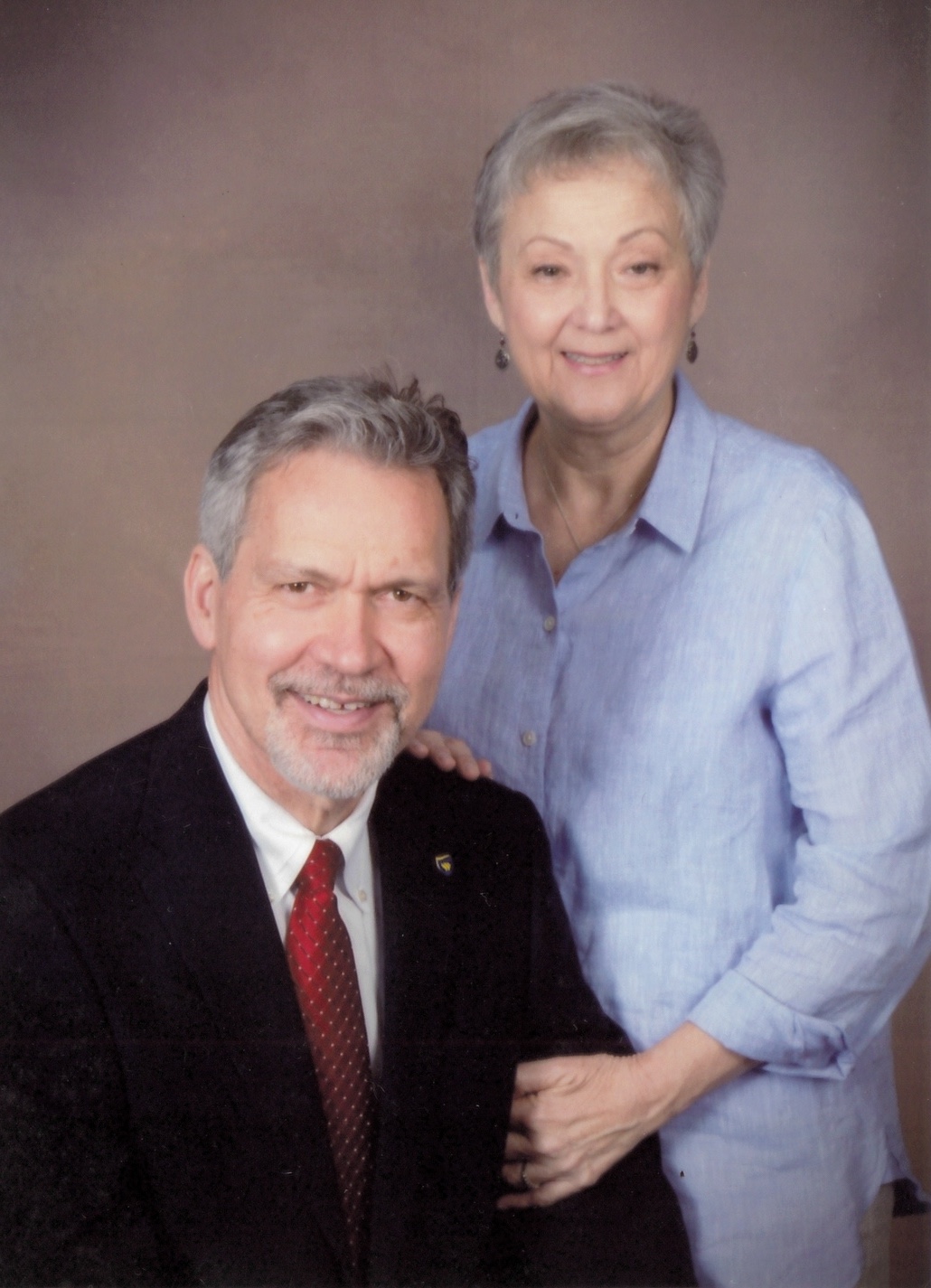 A posed photo of a senior couple taken in a photo studio