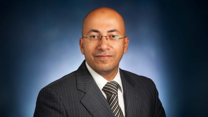 Headshot of a man with glasses on.