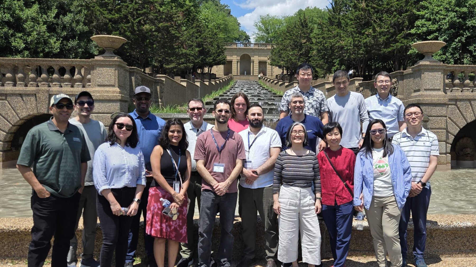 A group of people posing for a photo on a college campus.